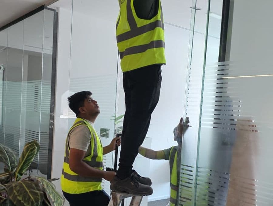 Pillarstone installation crew fitting glass on site in the UAE