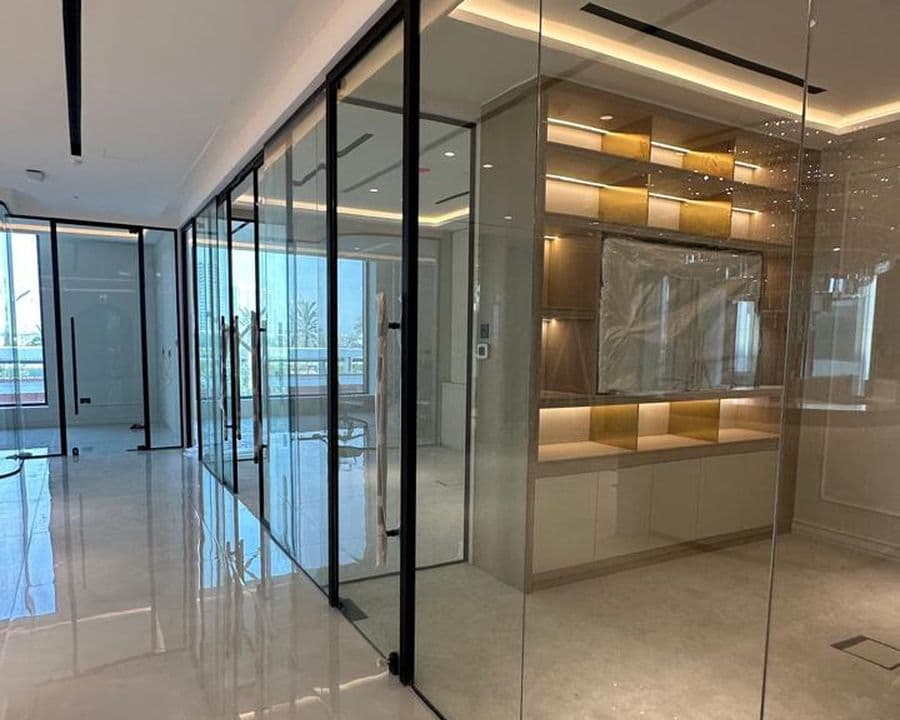 Clear tempered glass partition supplied and installed by Pillarstone in the UAE